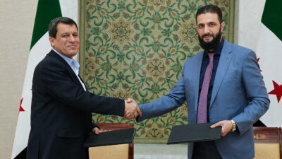 U.S.-backed Kurdish forces are merging with the Syrian government army,