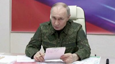 Speaking while dressed in fatigues, President Vladimir Putin says his